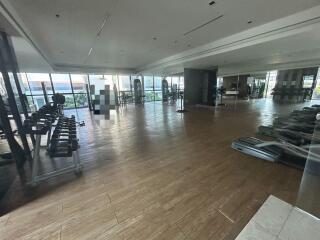 Spacious gym area with exercise machines and free weights