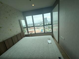 Bedroom with large window and city view