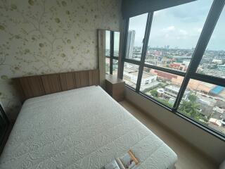 Bedroom with a large window and city view