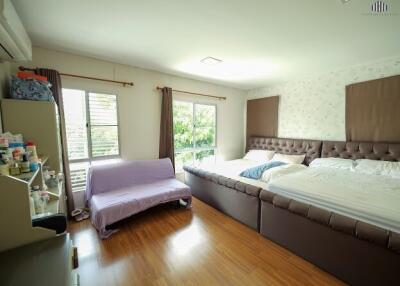 Spacious bedroom with large bed and window