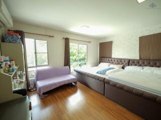 Spacious bedroom with large bed and window