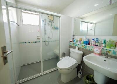 Modern bathroom with shower enclosure, toilet, and sink