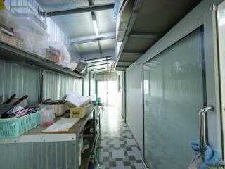 Long kitchen with storage shelves and tiled floor