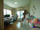 Bright home office with desks, computers, and balcony access