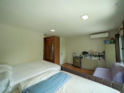 Spacious bedroom with double beds and ample storage