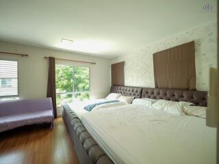 Spacious bedroom with large bed and ample natural light