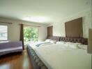 Spacious bedroom with large bed and ample natural light