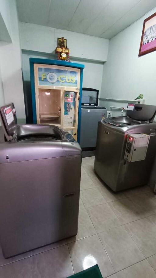 Laundry room with washing machines and a dryer