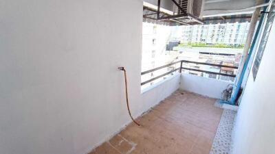 Simple balcony with a view of nearby buildings