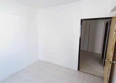 Empty room with white walls and tiled floor