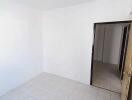 Empty room with white walls and tiled floor