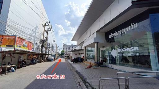 Street view of a commercial building with a signage area