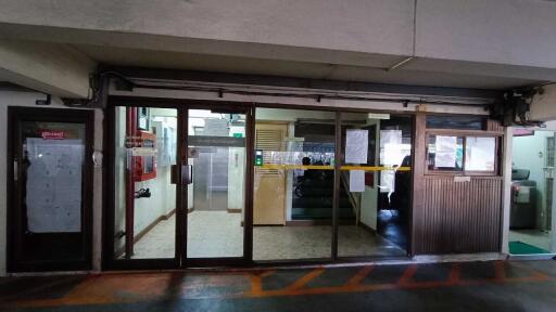 Entrance to a building with glass doors and notices