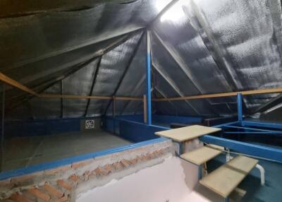Spacious attic with an industrial design and metal roofing