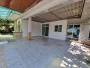 Spacious covered outdoor area with tiled floor