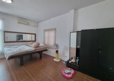 Spacious bedroom with bed, wardrobe, and air conditioning