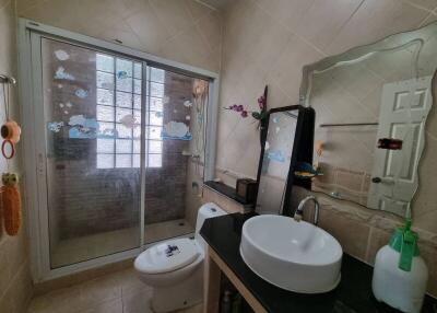 Bathroom with modern sink, shower, and decorative elements