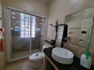 Bathroom with modern sink, shower, and decorative elements