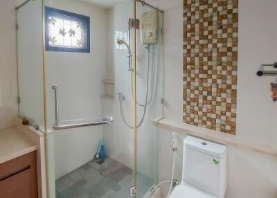 Modern bathroom with glass-enclosed shower and toilet