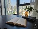 City view from a modern living room with a book and decorative plant