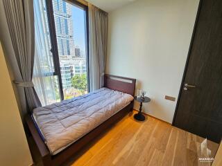 Modern bedroom with large window and city view