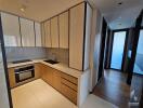 Modern kitchen with built-in appliances and wooden cabinetry