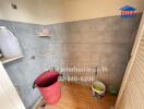 Bathroom with tiled walls and cleaning supplies