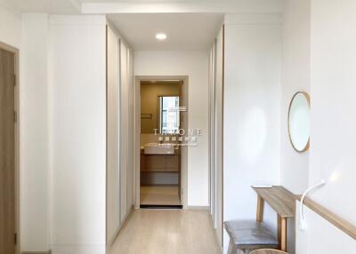 Main corridor with built-in cabinets leading to a bathroom