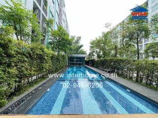 Outdoor swimming pool with surrounding greenery at a residential building