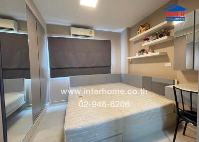 Modern bedroom with bed, built-in wardrobe, and shelves