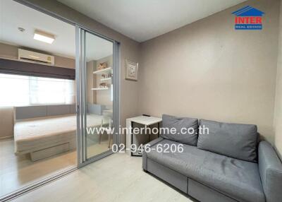 Bedroom with adjacent living area featuring a sliding glass door