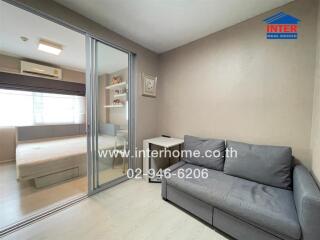 Bedroom with adjacent living area featuring a sliding glass door