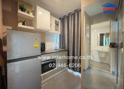 Modern kitchen area with appliances and bathroom view