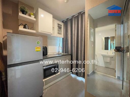 Modern kitchen area with appliances and bathroom view