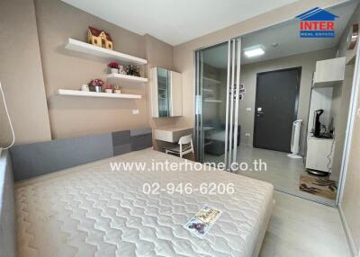 Bedroom with double bed, shelves, desk, and sliding glass door
