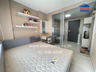 Bedroom with double bed, shelves, desk, and sliding glass door