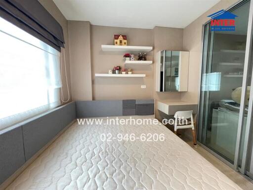 Modern bedroom with large window, built-in shelving, and desk area