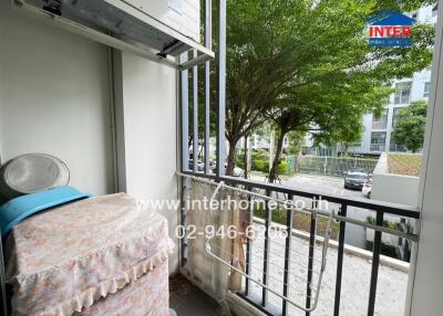 Balcony with outdoor view and laundry area