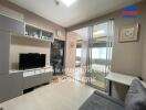 Living room with a TV, grey cabinet, and sliding glass doors