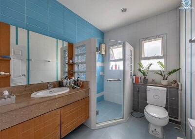 Modern bathroom with blue tiles and a glass shower