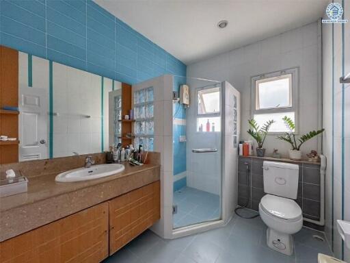 Modern bathroom with blue tiles and a glass shower