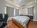 Bedroom with double bed, office chair, and air conditioning