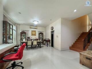 Spacious dining area with a view of the staircase and part of the living room