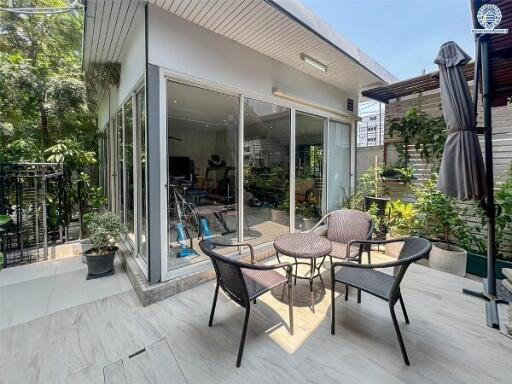 Outdoor patio adjacent to a modern glass-enclosed indoor space