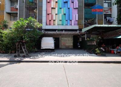 Colorful multi-level building exterior with commercial spaces