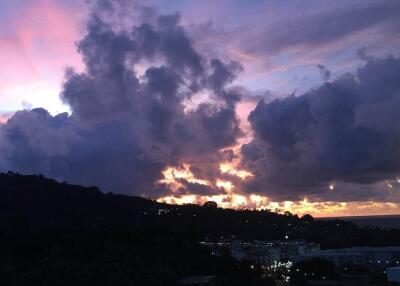 Scenic view of a mountainous area during sunset with clouds in the sky