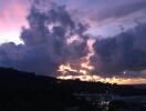 Scenic view of a mountainous area during sunset with clouds in the sky