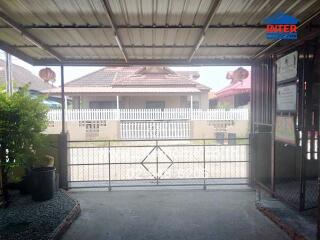 Covered garage with view of neighboring house