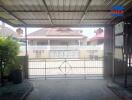 Covered garage with view of neighboring house