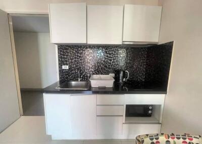 Small modern kitchen with black backsplash